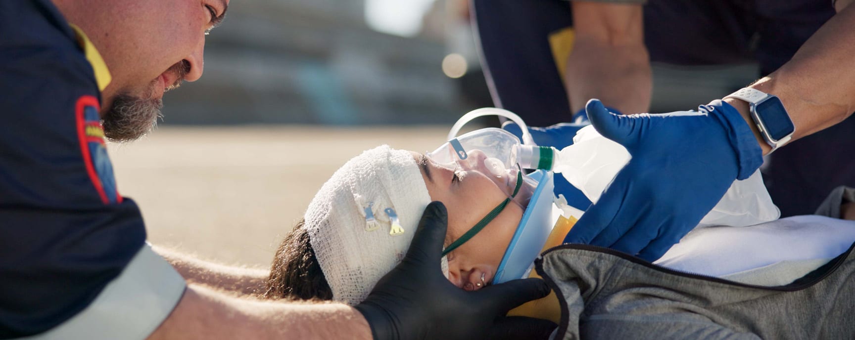Paramedics performing concussion check on a motorcycle accident victim